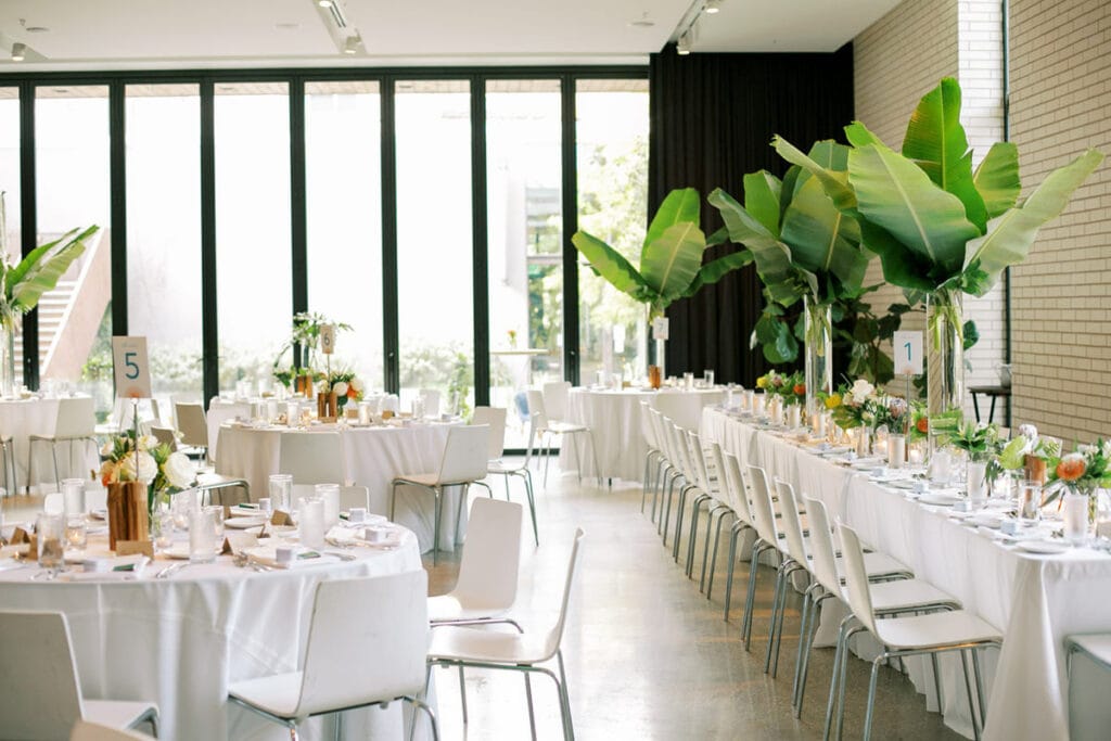 south congress hotel wedding reception room with tropical plants on tables